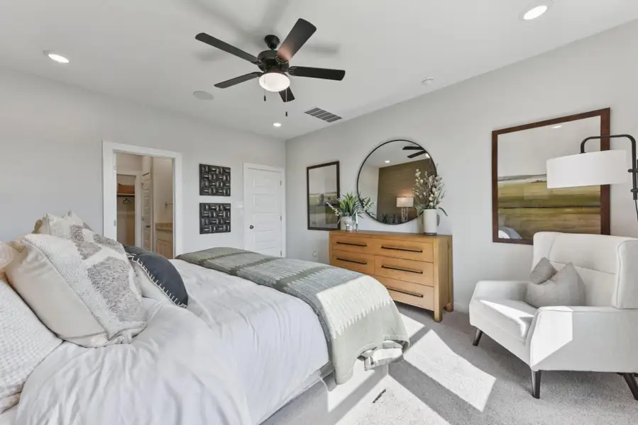 Carpeted bedroom with recessed lighting, a ceiling fan, and ensuite bath