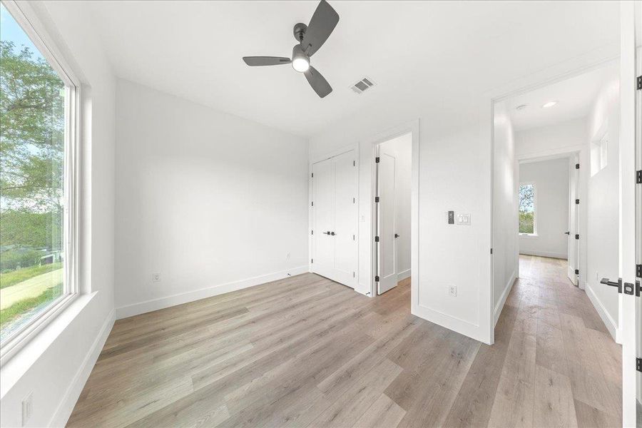 Unfurnished bedroom featuring light wood-style floors, a ceiling fan, and recessed lighting Unfurnished bedroom featuring light wood-style floors, a ceiling fan, and recessed lighting