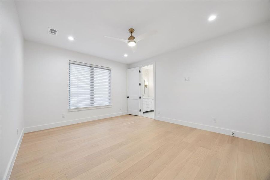 Secondary bedroom with ensuite bath, warm wood floors, and a comfortable, light-filled layout. Secondary bedroom with ensuite bath, warm wood floors, and a comfortable, light-filled layout.