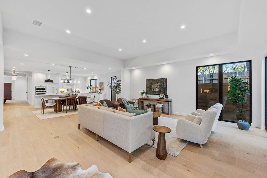 Living area with recessed lighting and light wood finished floors