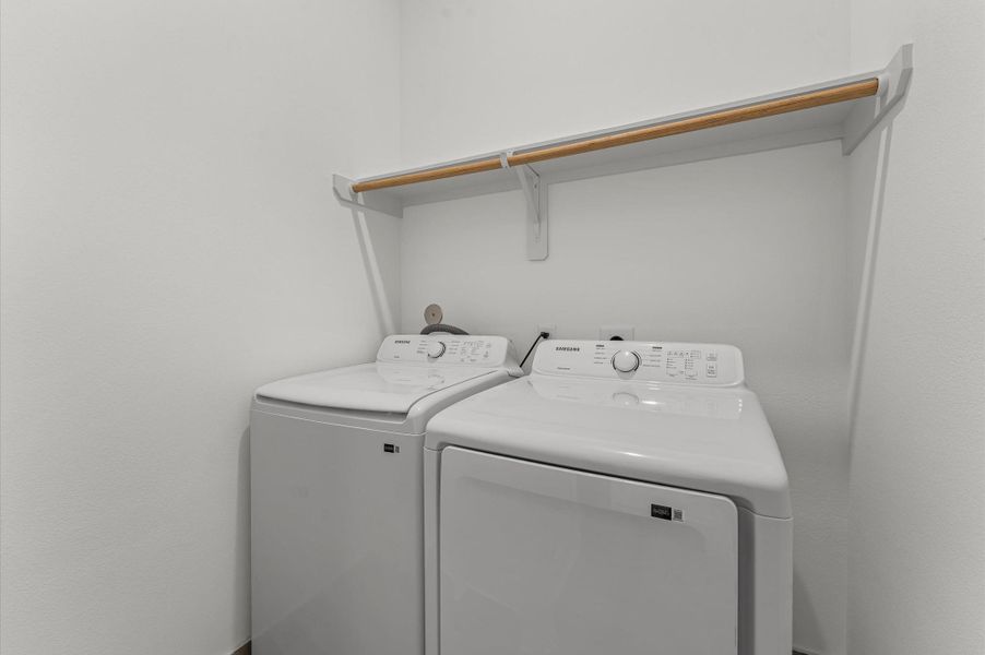 Conveniently located on the second floor, this well-appointed laundry room offers easy access from nearby bedrooms—streamlining daily routines and eliminating the need to carry laundry up and down stairs.