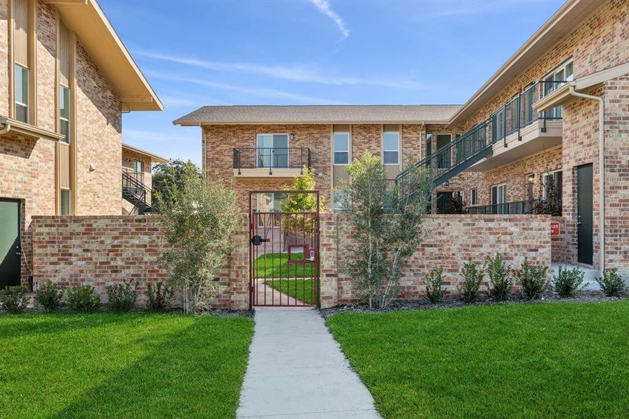 View of front of property featuring a gate and courtyard