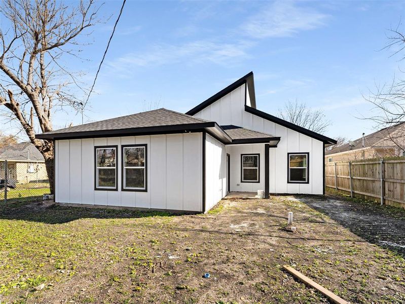 Rear view of property featuring a lawn