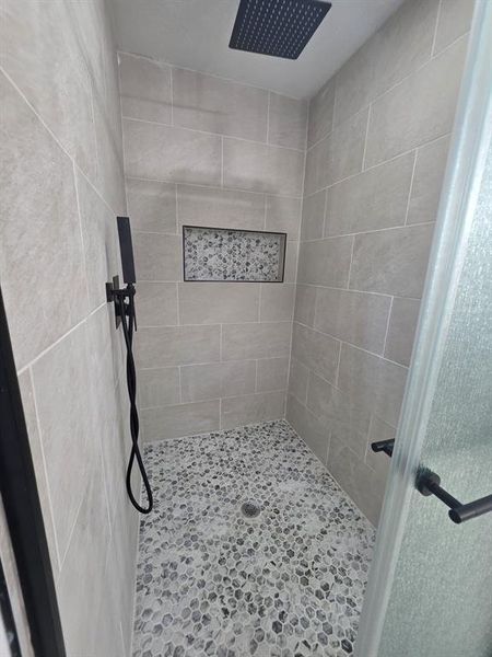 Full bathroom with a tile shower Full bathroom with a tile shower