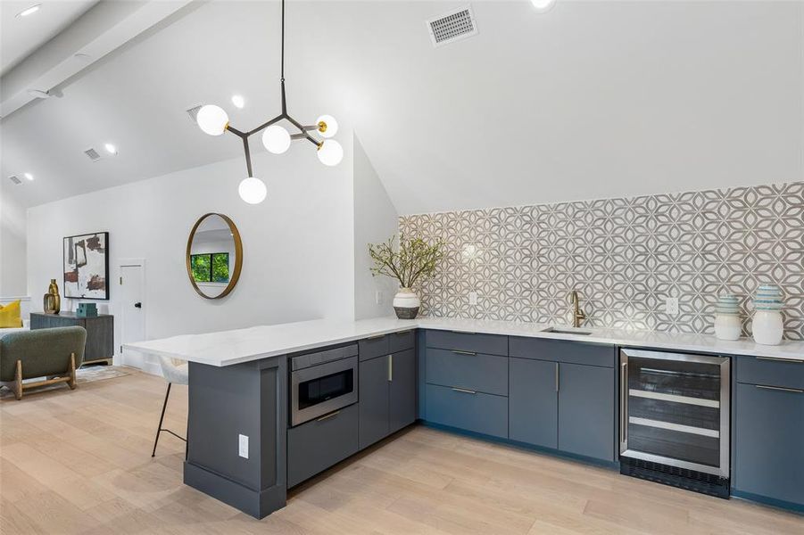 Upstairs entertaining area with built-in bar, beverage fridge, and stylish finishes, ideal for hosting or relaxing.