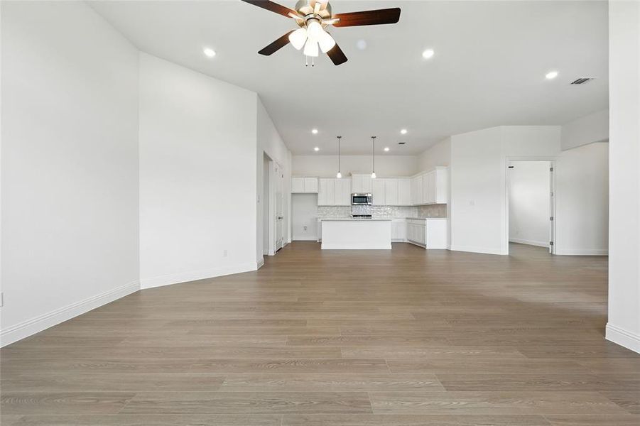 Unfurnished living room with recessed lighting, light wood finished floors, and a ceiling fan