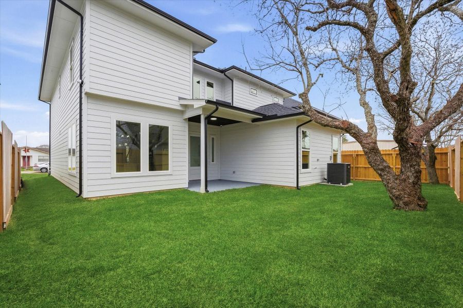 The backyard includes a covered porch, full perimeter gutters, and exterior security cameras for added peace of mind.