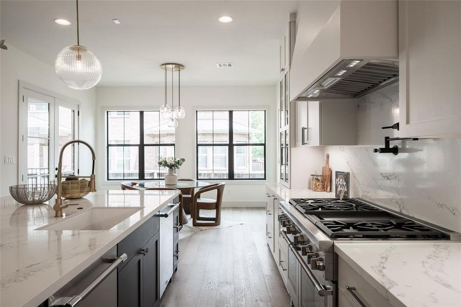 Step into culinary luxury in this new construction home, boasting a kitchen equipped with dual dishwashers, dual ovens, a six-burner Thermador range, a pot filler, and a commercial-grade ventilation system.