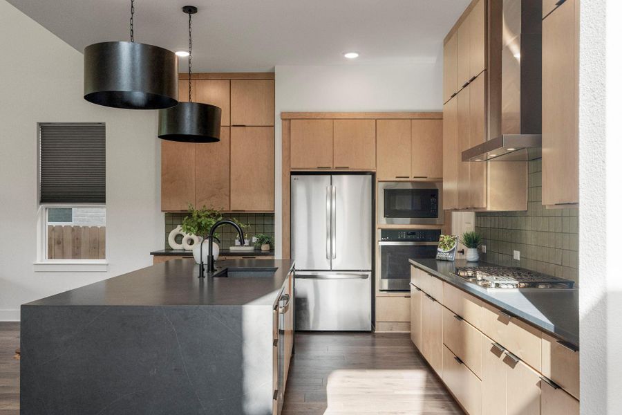 Modern cabinetry and stainless steel appliances complete this thoughtfully designed kitchen space.