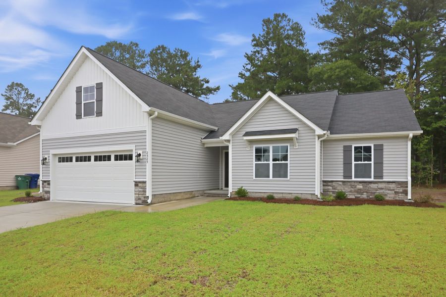 Front exterior of a new home in Davenport Farms, Winterville, NC, highlighting curb appeal (Image 21). Front exterior of a new home in Davenport Farms, Winterville, NC, highlighting curb appeal (Image 21).