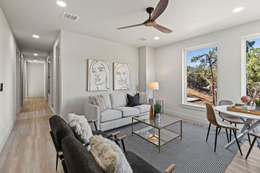 Living area featuring recessed lighting, visible vents, baseboards, and light wood finished floors