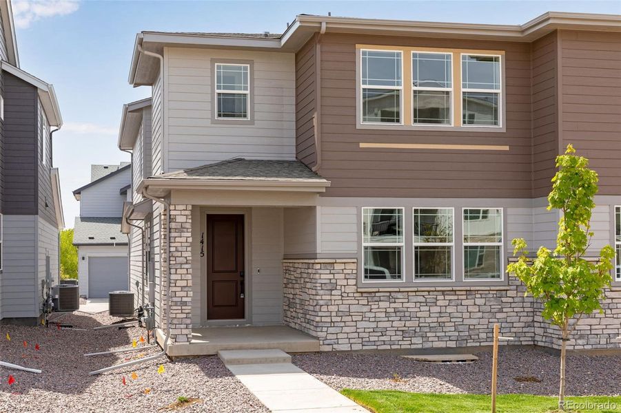 Front exterior of a new home in Sugar Mill Village, Longmont, CO, highlighting curb appeal (Image 2). Front exterior of a new home in Sugar Mill Village, Longmont, CO, highlighting curb appeal (Image 2).