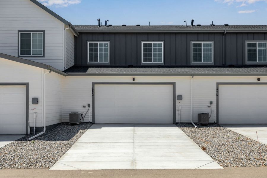 Front exterior of a new home in Westside Crossing Townhomes, Berthoud, CO, highlighting curb appeal (Image 2).