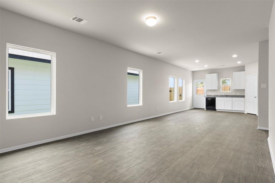 Unfurnished living room with recessed lighting and wood finished floors Unfurnished living room with recessed lighting and wood finished floors