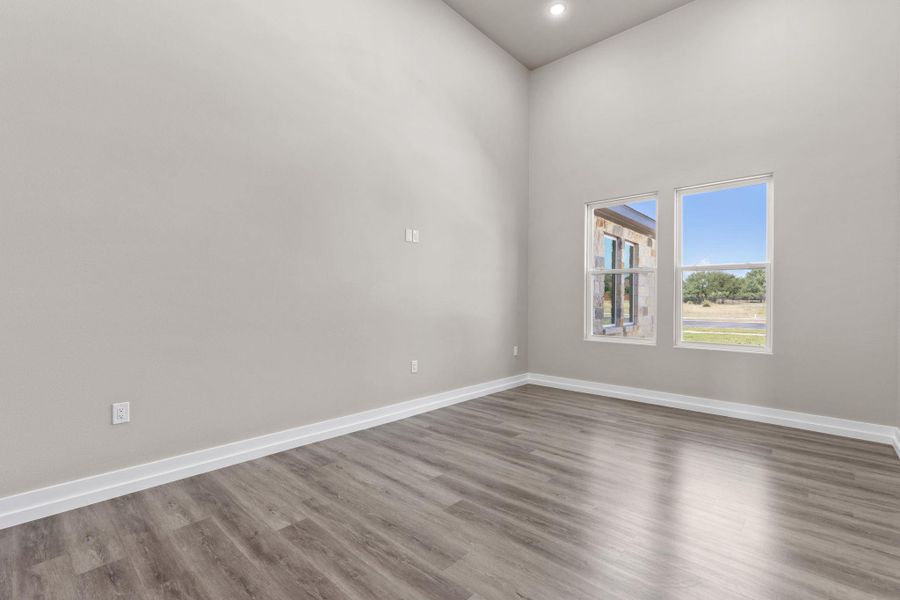 Natural light fills this flex room with high ceilings and durable wood-look flooring. Natural light fills this flex room with high ceilings and durable wood-look flooring.
