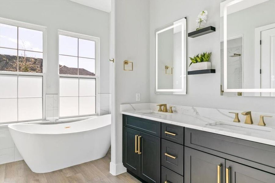 Master bathroom with dual vanity, lighted mirrors