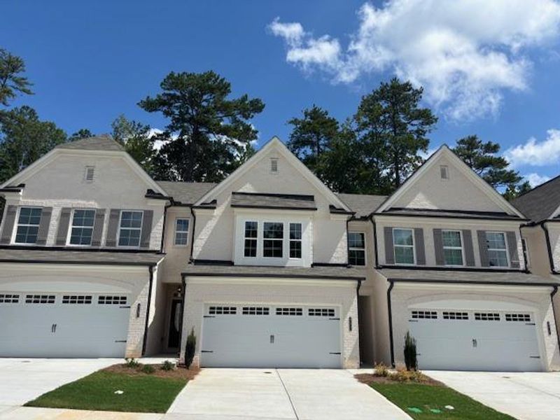 Front exterior of a new home in Riversong, Duluth, GA, highlighting curb appeal (Image 16).