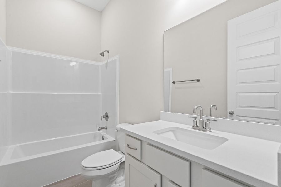 Full bathroom featuring  shower combination, vanity, and tile patterned flooring