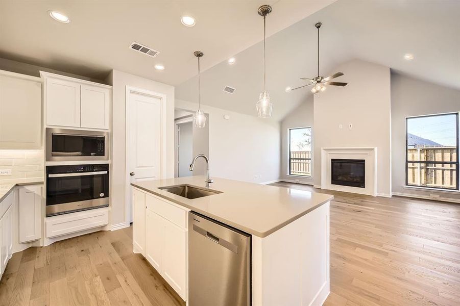 Kitchen featuring white cabinets, plenty of natural light, and appliances with stainless steel finishes