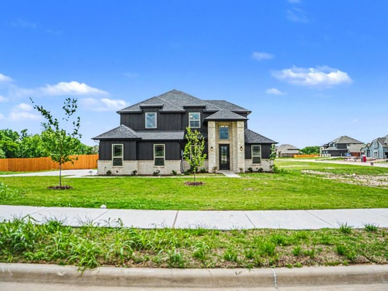 Front exterior of a new home in Ten Mile Creek Estates, DeSoto, TX, highlighting curb appeal (Image 16). Front exterior of a new home in Ten Mile Creek Estates, DeSoto, TX, highlighting curb appeal (Image 16).