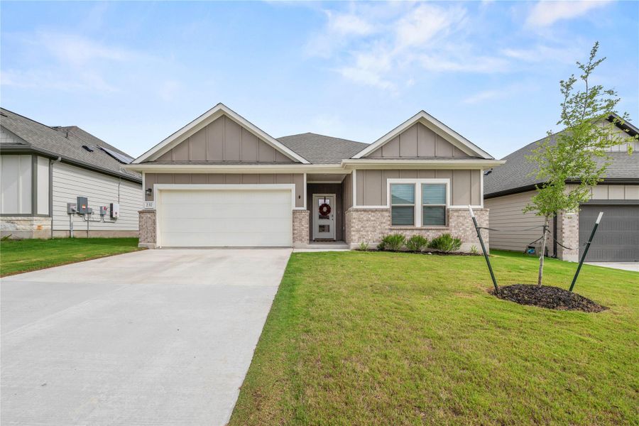 A welcoming facade presents a harmonious blend of neutral tones and brick accents, complemented by a verdant lawn. A welcoming facade presents a harmonious blend of neutral tones and brick accents, complemented by a verdant lawn.