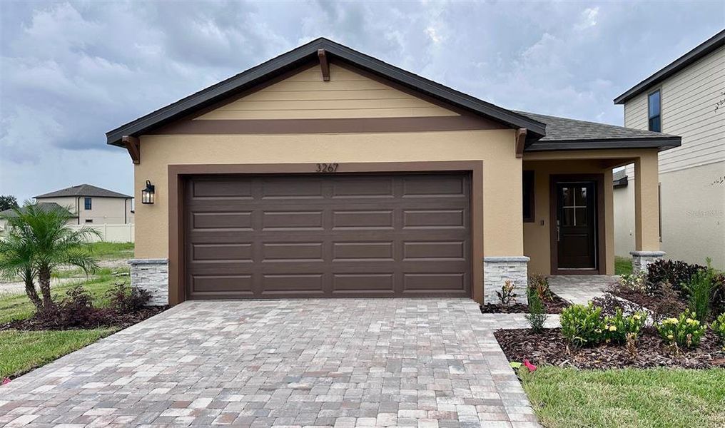 Front exterior of a new home in Grasslands West, Lakeland, FL, highlighting curb appeal (Image 2).