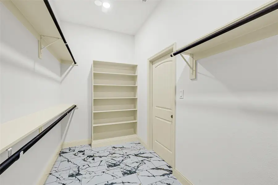 Check out this primary bed mega walk-in closet. Check out this primary bed mega walk-in closet.