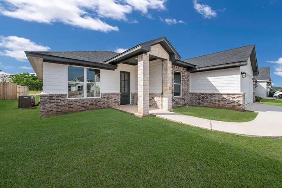 View of front facade featuring brick siding and concrete driveway View of front facade featuring brick siding and concrete driveway