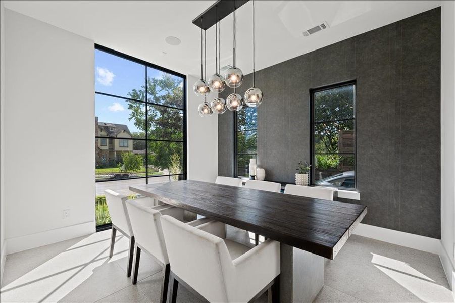 Dining area featuring a chandelier and expansive windows