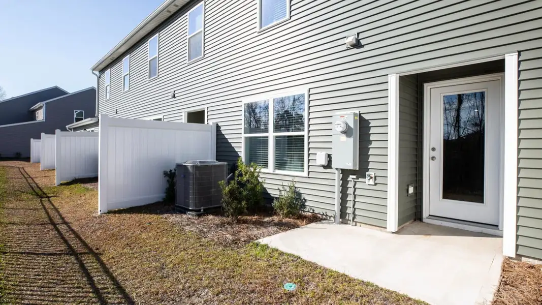 Exterior details and patio area of a home in Indigo Preserve Townhomes, Leland (Image 3).