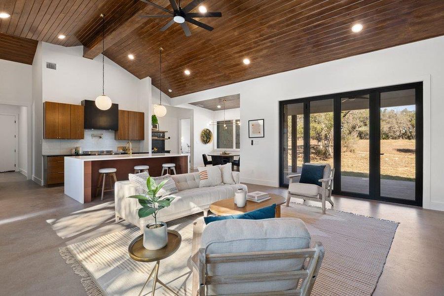 Living room with concrete flooring, high vaulted ceiling, a wood ceiling with exposed beams, a ceiling fan, and recessed lighting