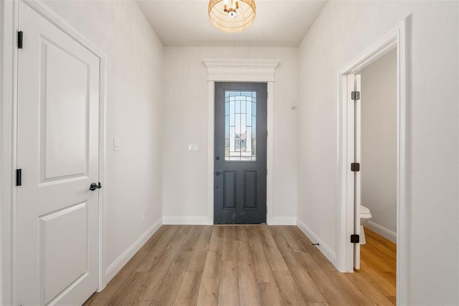 Entryway featuring light wood-style floors and baseboards