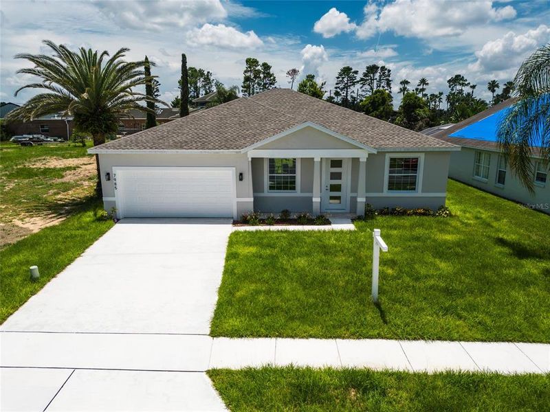 Front exterior of a new home in , Kissimmee, FL, highlighting curb appeal (Image 2).