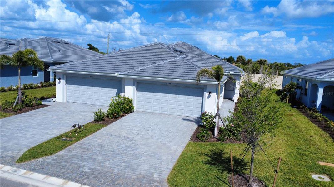 Front exterior of a new home in Palm Lake at Coco Bay, Englewood, FL, highlighting curb appeal (Image 23).