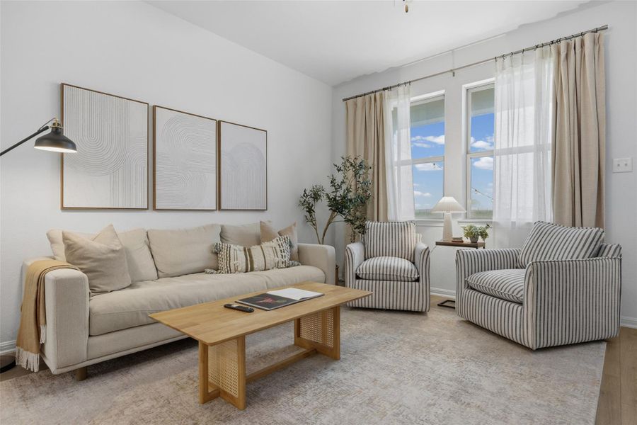 Living area featuring light-toned walls and wood-finish flooring