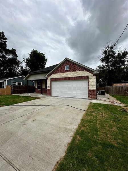 View of front of property with a garage and a front yard