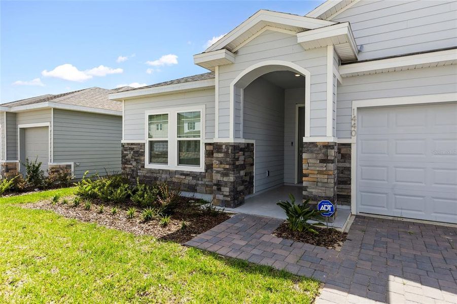 Front exterior of a new home in , Newberry, FL, highlighting curb appeal (Image 22).