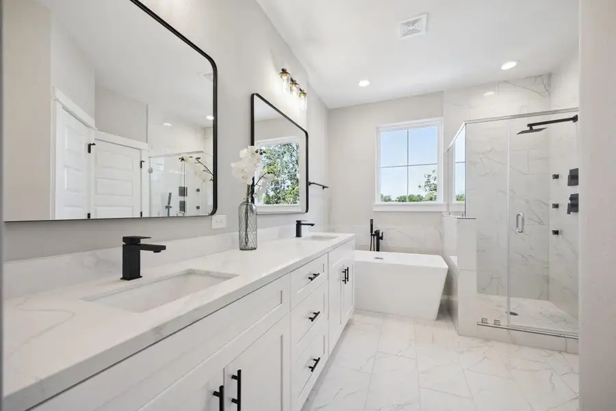 Primary bath features double vanities, soaking tub and walk-in shower Primary bath features double vanities, soaking tub and walk-in shower