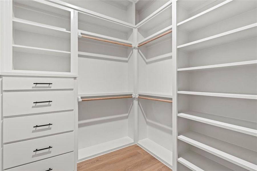 Spacious closet with light wood finished floors Spacious closet with light wood finished floors