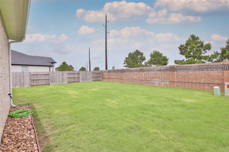 No need to worry about storms taking out your back fence—durability meets peace of mind here. With plenty of open space, this backyard is ready for you to get creative and truly make it your own! No need to worry about storms taking out your back fence—durability meets peace of mind here. With plenty of open space, this backyard is ready for you to get creative and truly make it your own!
