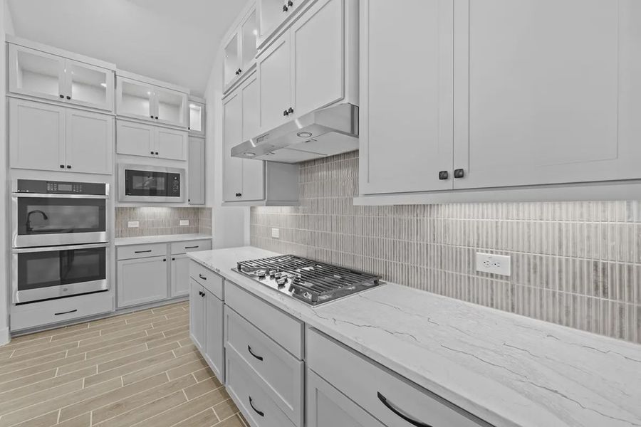 Representative furnished interior of a home built from the Summerton by Chesmar Homes in University Heights, Round Rock (Image 10).