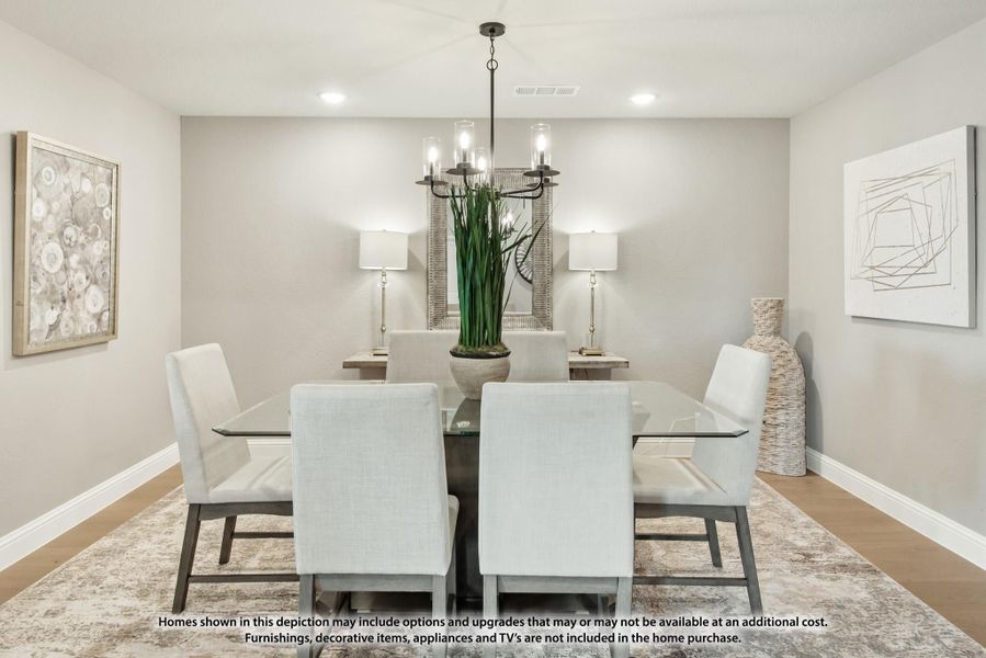 Dining room with glass-top table, six white upholstered chairs, and a chandelier overhead
