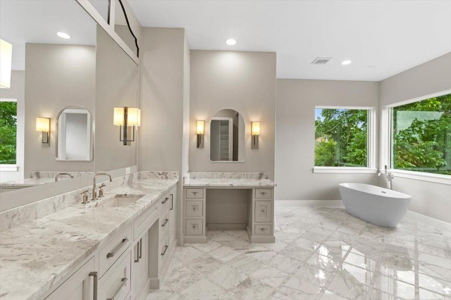Make up vanity features an outlet drawer...marble shower and stand alone tub