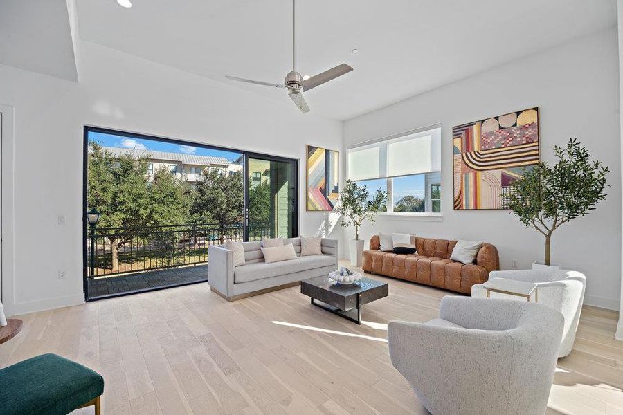 Living area with a ceiling fan and light wood finished floors Living area with a ceiling fan and light wood finished floors