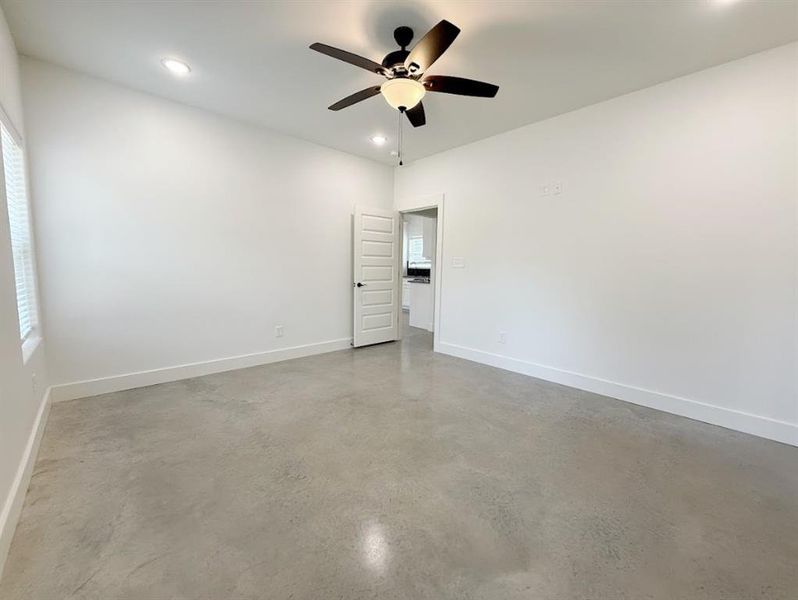 Unfurnished room with finished concrete floors, recessed lighting, and ceiling fan Unfurnished room with finished concrete floors, recessed lighting, and ceiling fan