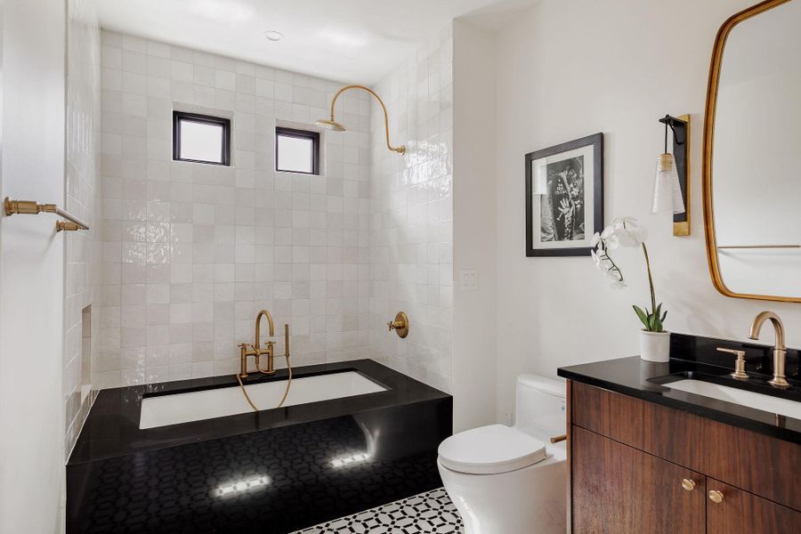 Crisp tilework, soft lighting, and modern fixtures create a cohesive aesthetic carried throughout the home’s private spaces. Crisp tilework, soft lighting, and modern fixtures create a cohesive aesthetic carried throughout the home’s private spaces.