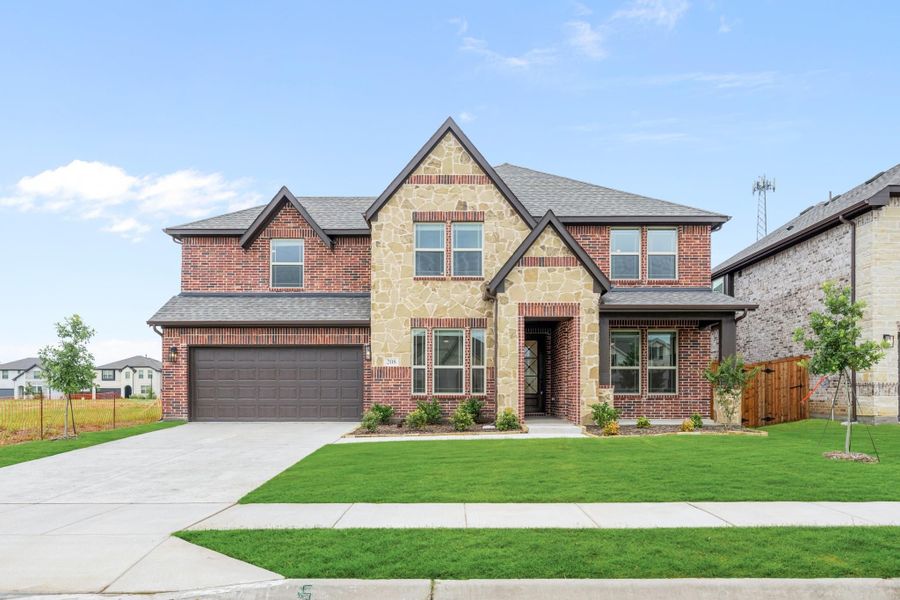 Two-story home with brick and stone exterior, two-car garage, and green front lawn Two-story home with brick and stone exterior, two-car garage, and green front lawn