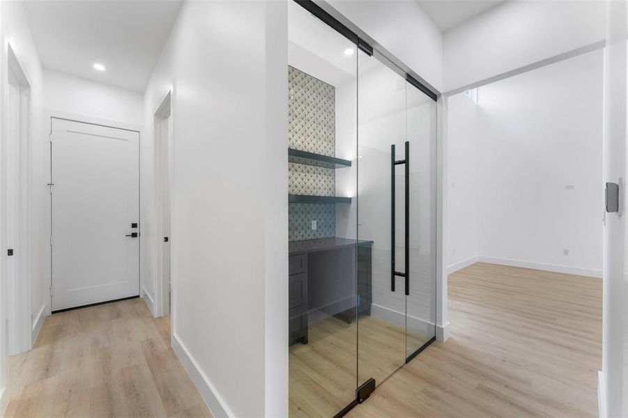 Hallway featuring light wood-style floors and recessed lighting