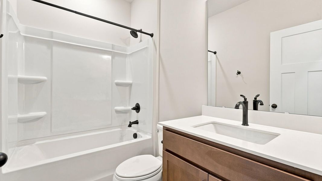 Top-notch bathroom with current fixtures, tasteful materials, and elevated charm at the Fox Hollow community
