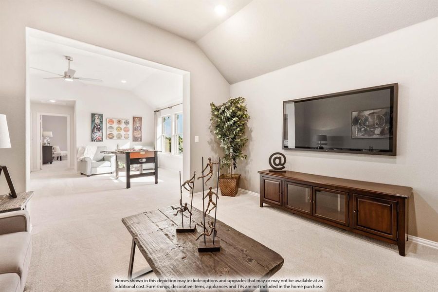 Living room with vaulted ceiling, wall-mounted TV, wood media console, and open view to game room with foosball table.